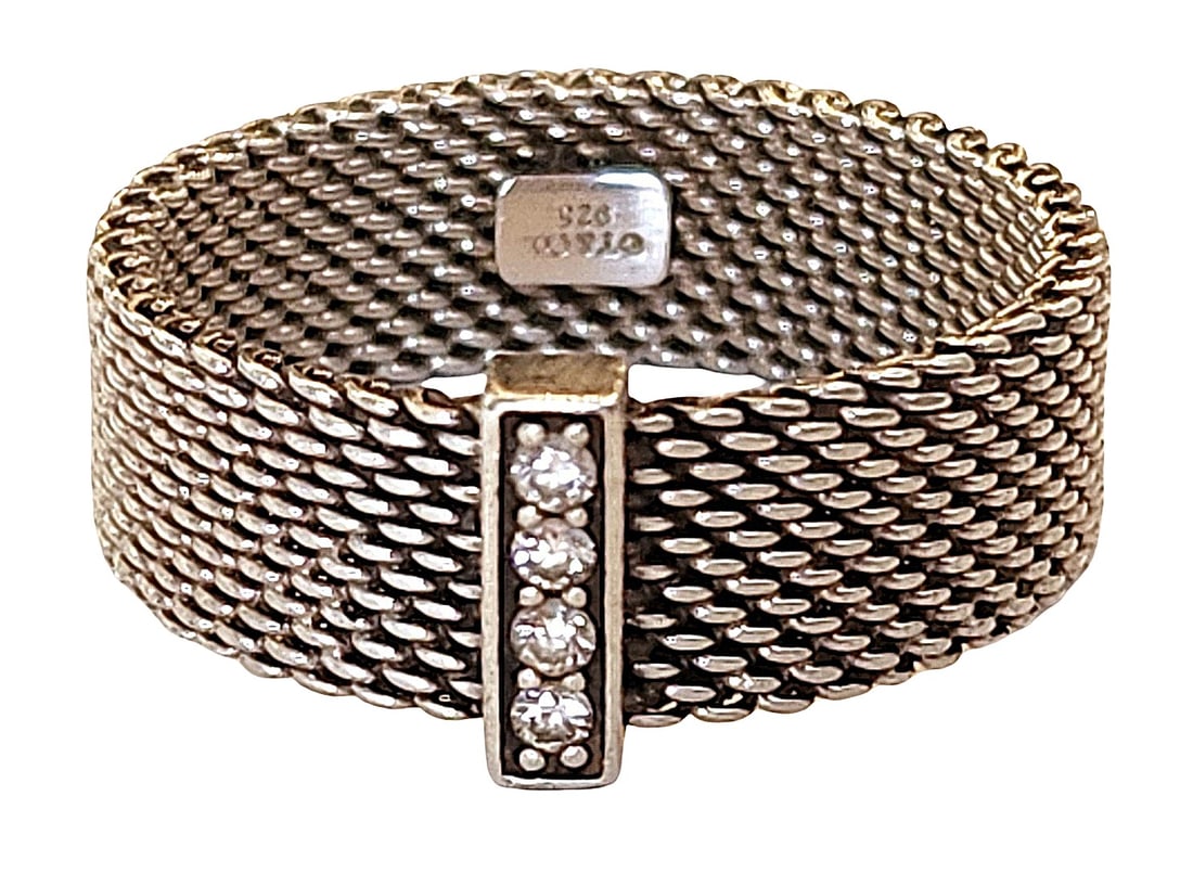 Tiffany & Co. Sterling Silver Mesh Ring with Diamond Bar – 925 Wide Band: Authentic Tiffany & Co. sterling silver mesh ring featuring a wide woven band design with a vertical bar set with five round diamonds. The flexible mesh style gives the ring a distinctive textured loo