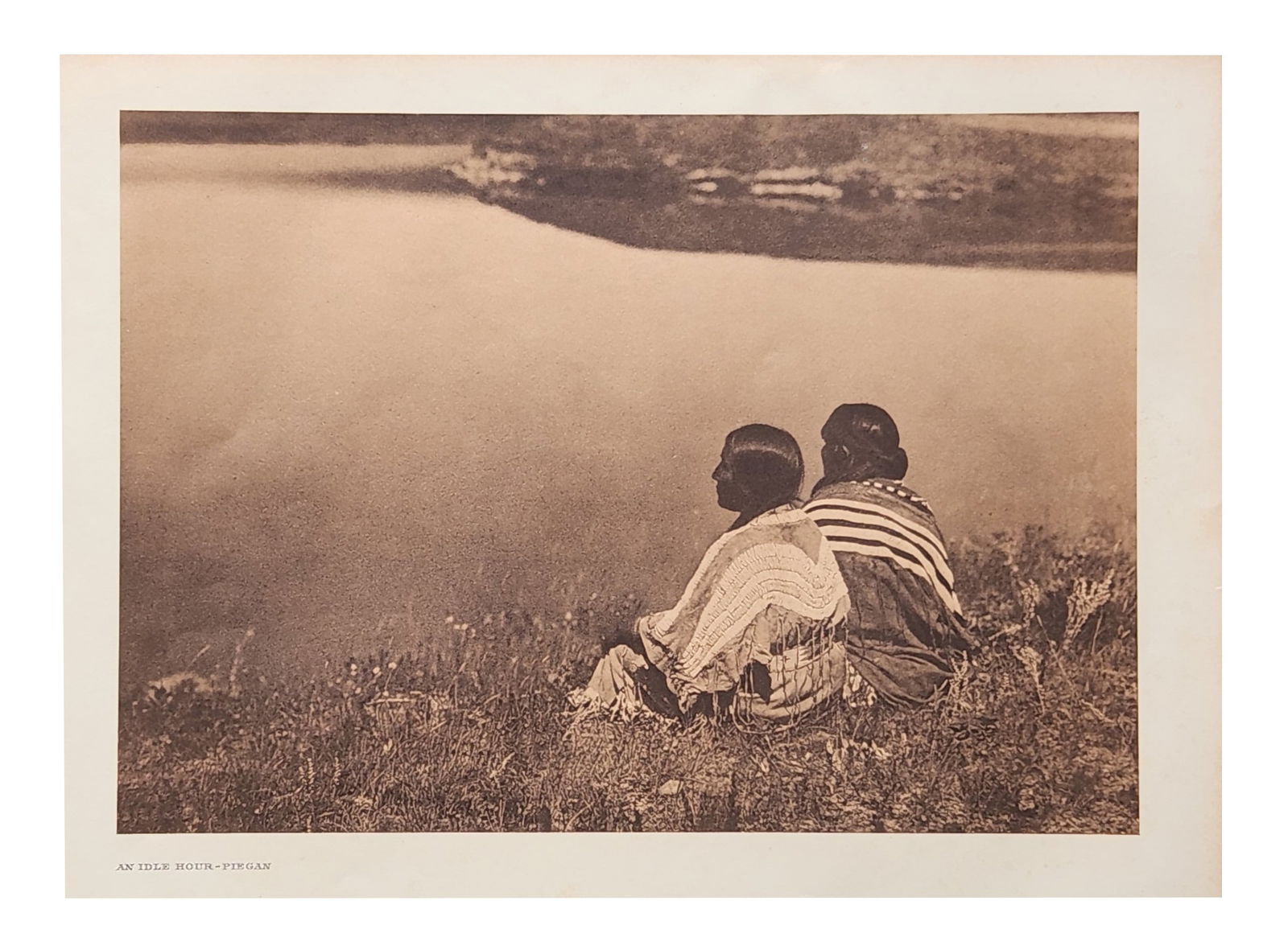Edward Sheriff Curtis (1868 - 1952) American: Edward Sheriff Curtis (1868 - 1952) American Title: An Idle Hour - Piegan Print Caption - Engraving Date: 1910 Measure 13"in H x 18"in W no framed