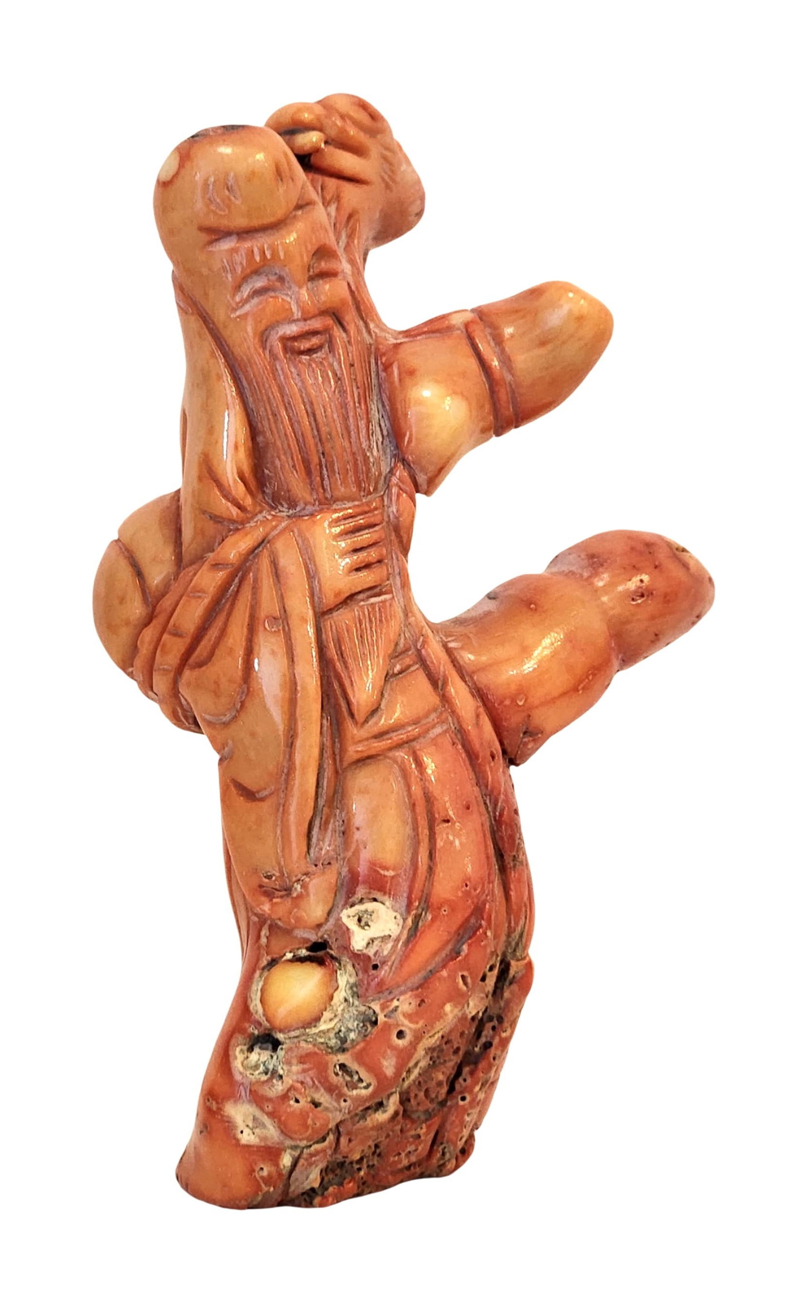 Antique Carved Red Coral Figure of an Immortal, Mid-20th Century: A finely carved red coral figure depicting an immortal with long beard and flowing robes, shown holding a staff. The piece highlights the natural texture and inclusions of Mediterranean red coral, add