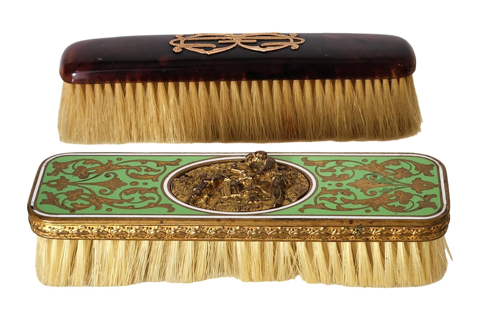 Pair of Antique Vanity Brushes – French Enamel & Faux Tortoiseshell with Gilt Detailing: Elegant pair of antique vanity brushes, each with distinct decorative styling: The first features a deep faux tortoiseshell (or early plastic/baquelite) top adorned with a gilt ribbon appliqué. The s