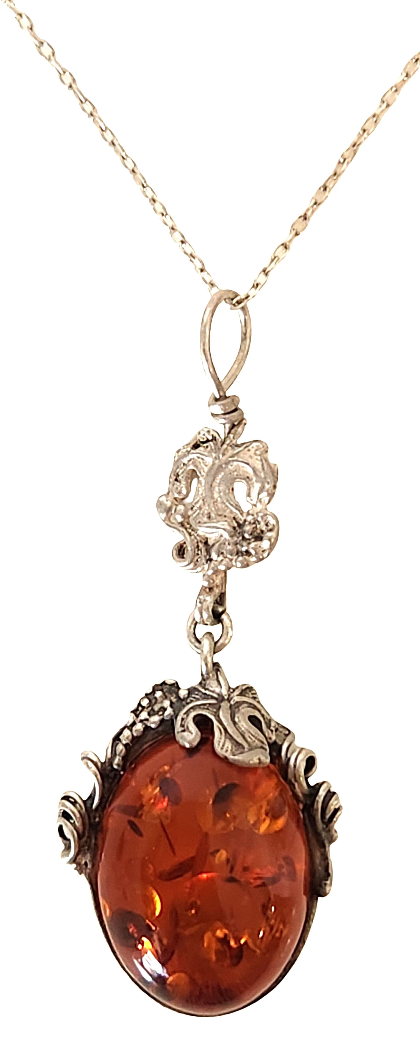 Sterling Silver 925 Amber Cabochon Pendant Necklace: An elegant sterling silver necklace featuring a warm amber cabochon pendant. The oval amber stone displays rich honey and cognac tones with visible natural inclusions, adding depth and organic charact