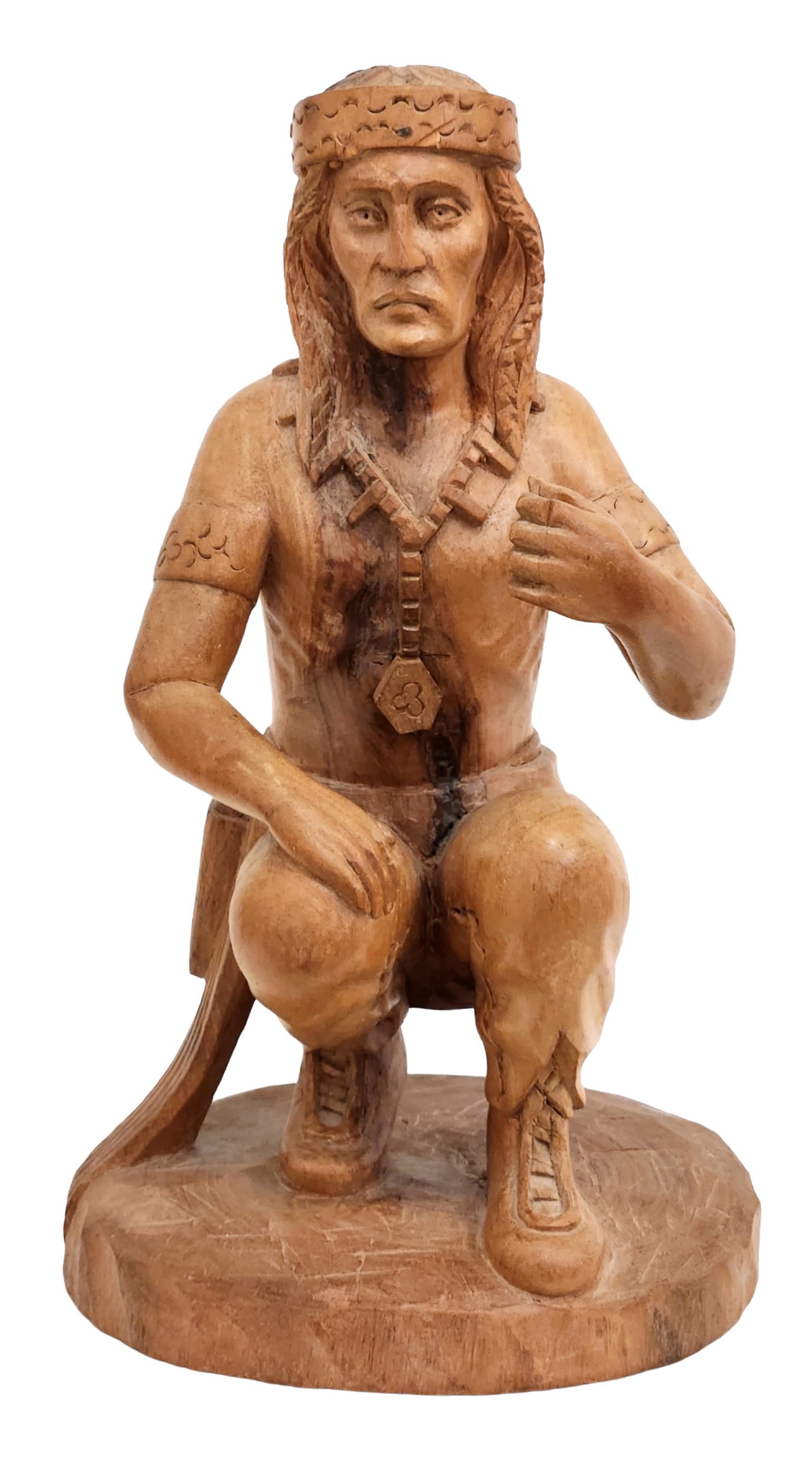 Carved Wood Sculpture of a Native Figure, Signed Sabage: Hand-carved wooden sculpture depicting a kneeling Native figure in traditional attire, including detailed headdress, necklace, and moccasins. The carving highlights expressive facial features and natu