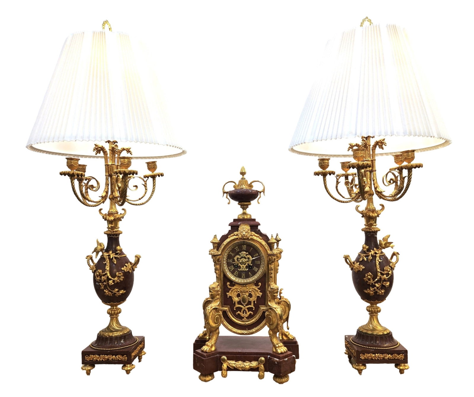 19th Century French Gilt Bronze & Marble Clock Garniture Set with Candelabra Lamps: Elegant 19th century French three-piece garniture set comprising a central mantel clock and a pair of converted candelabra lamps. The clock is crafted from rouge marble and gilt bronze, featuring orna
