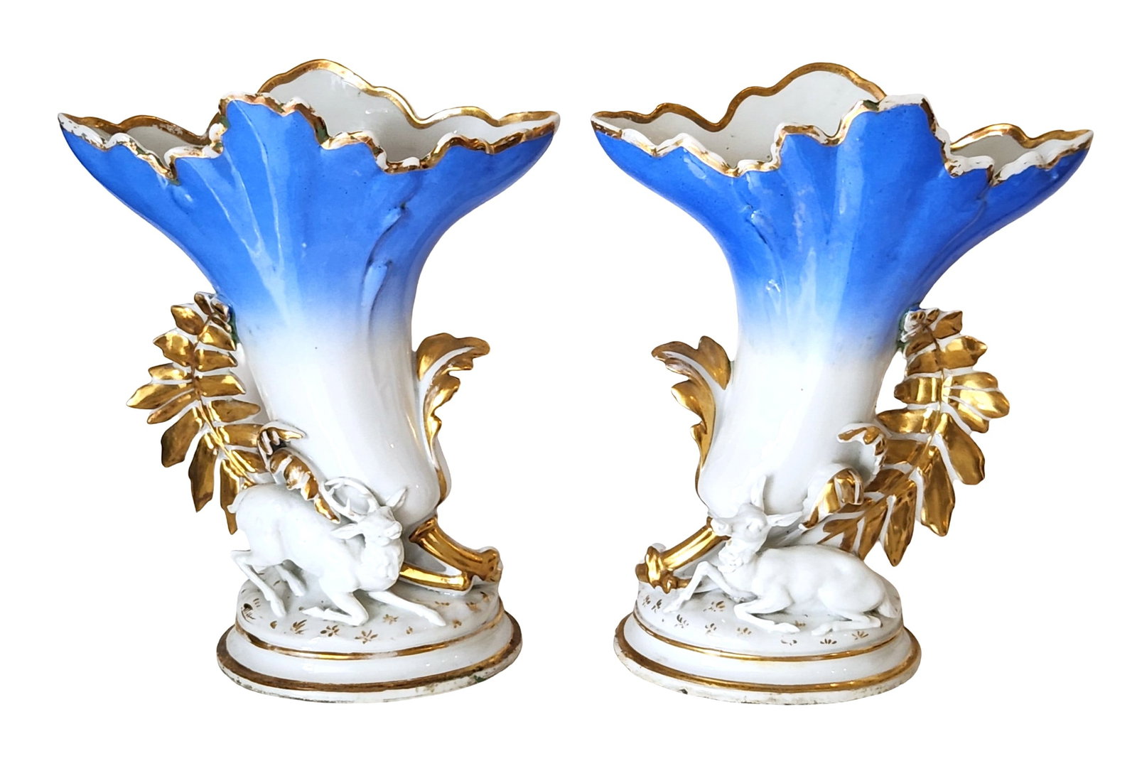 Pair of Old Paris Porcelain Cornucopia Vases with Gilt Deer, Possibly 19th Century: A charming pair of Old Paris porcelain cornucopia vases, possibly dating to the 19th century. Each features a flaring trumpet form hand-painted in a cobalt-to-white gradient and lavishly highlighted i