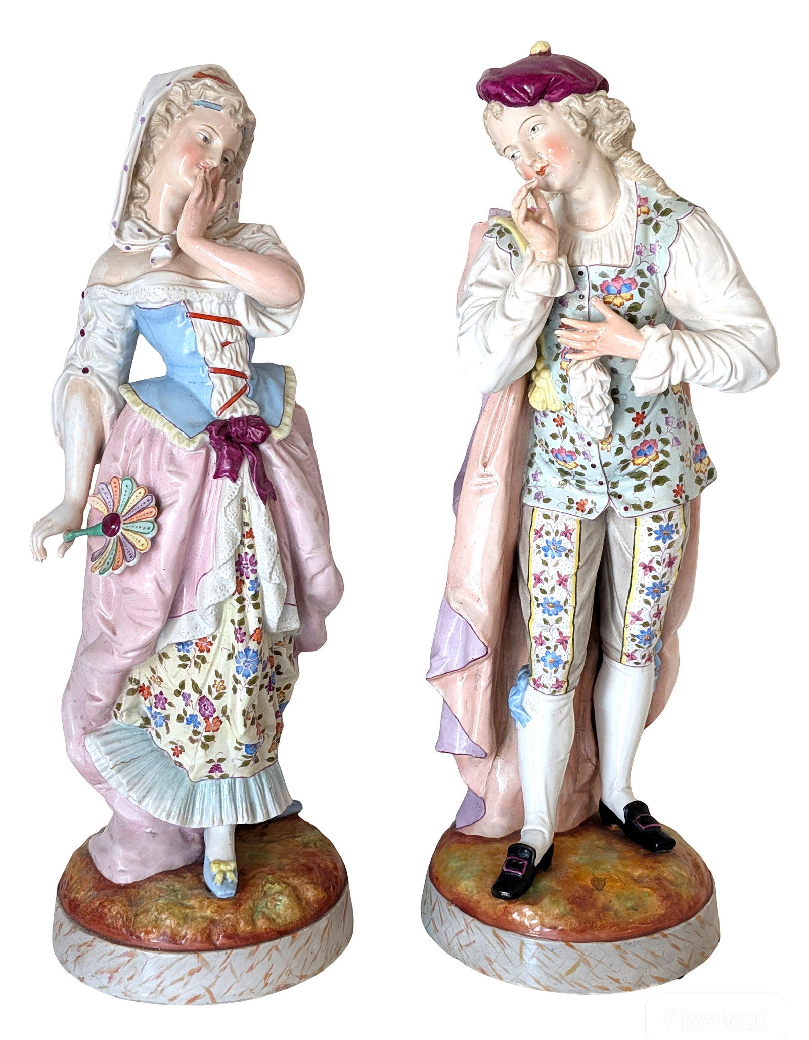 Pair of Continental Porcelain Courtly Figures: Decorative pair of hand-painted porcelain figures depicting an elegantly dressed courting couple in 18th-century attire. The female figure wears a bonnet and flowing pink gown while holding a flower; 