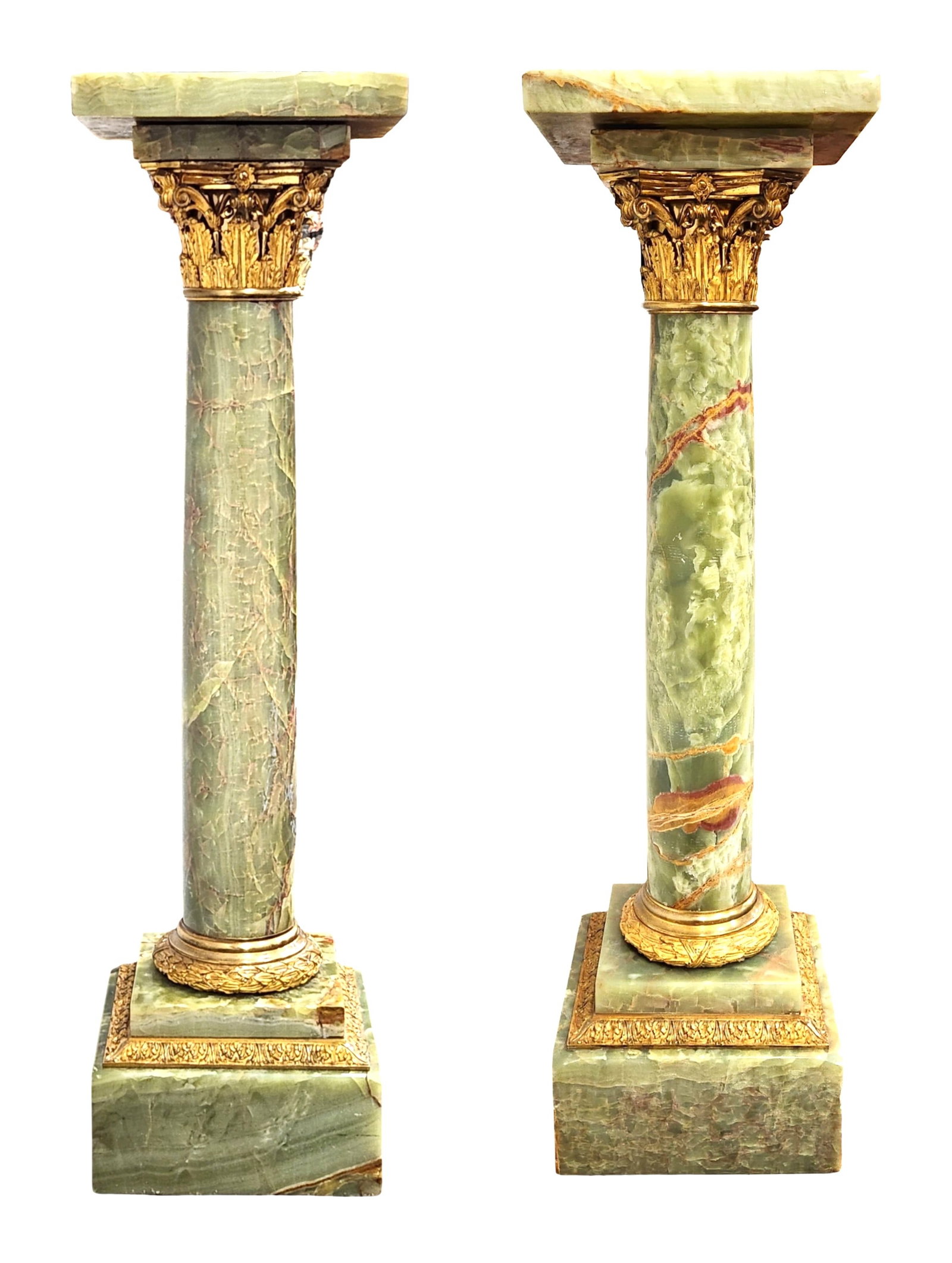 Pair of Green Onyx Corinthian Pedestals with Gilt Bronze Mounts: A handsome pair of Corinthian-style pedestals crafted in richly veined green onyx, each topped with a square onyx capital supported by a tapered column terminating in a stepped onyx plinth. The capita