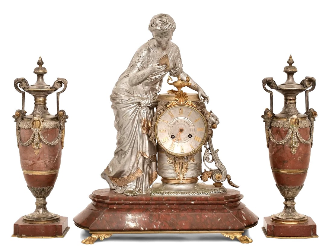 19th Century French Silvered Bronze and Rouge Marble Clock Garniture Set, Marked Juvenaux: Exquisite 19th-century French three-piece clock garniture set, featuring a central figural mantel clock flanked by matching urns. The clock presents a finely cast silvered bronze figure of a classical
