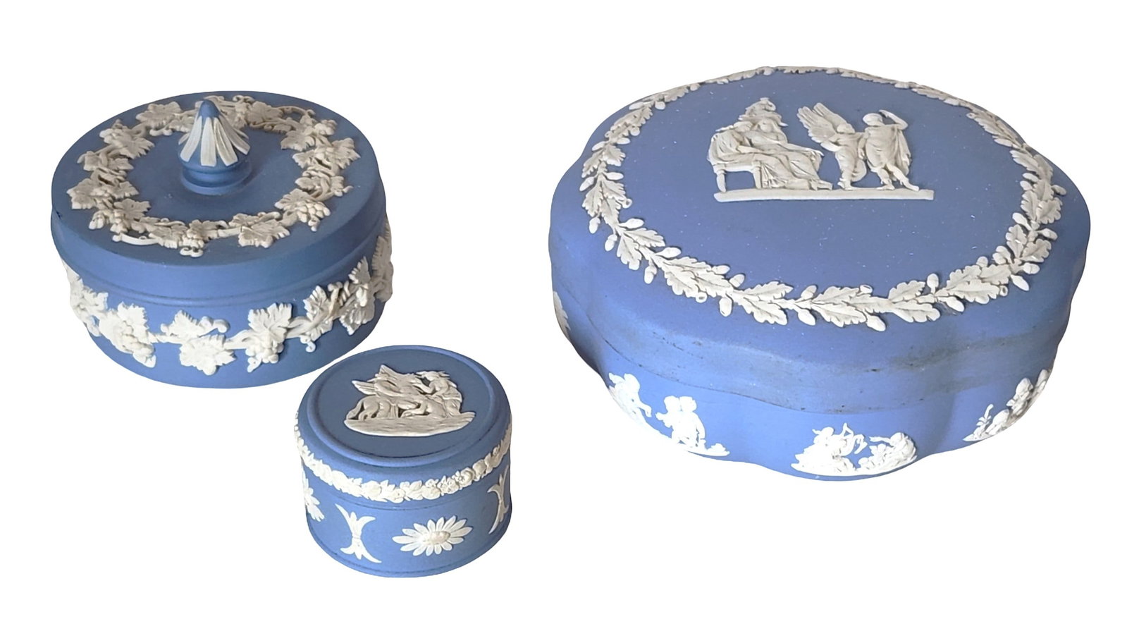 Set of 3 Wedgwood Jasperware Blue & White Trinket Boxes, Made in England: Charming set of three Wedgwood Jasperware trinket boxes in iconic blue with applied white classical relief decoration. This collection includes one heart-shaped box, one domed round box with finial li