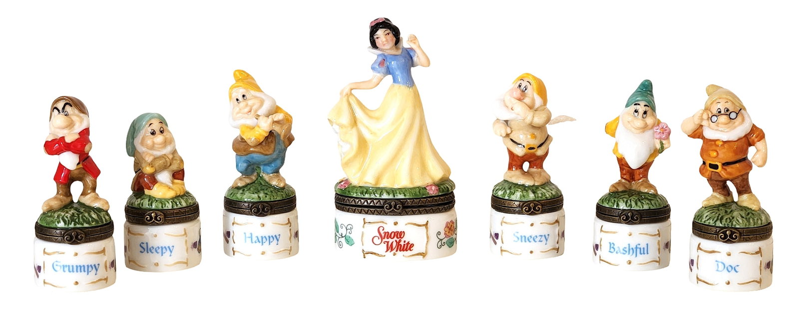 Disney Snow White & the Seven Dwarfs Porcelain Hinged Trinket Box Set ? PHB Collection (7 Pieces): Charming vintage Disney collectible set from the PHB Collection, featuring Snow White and six dwarfs: Grumpy, Sleepy, Happy, Sneezy, Bashful, and Doc. Each hand-painted porcelain figurine sits atop a 