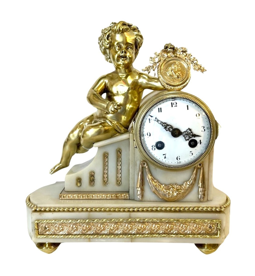 Late 19th century French White Marble and Gilt Bronze Figural Mantel Clock: Late 19th century French White Marble and Gilt Bronze Figural Mantel Clock The gilt bronze drum case surmounted by a bronze figure of a cherub in the manner of Henri Dasson the painted white enamelled