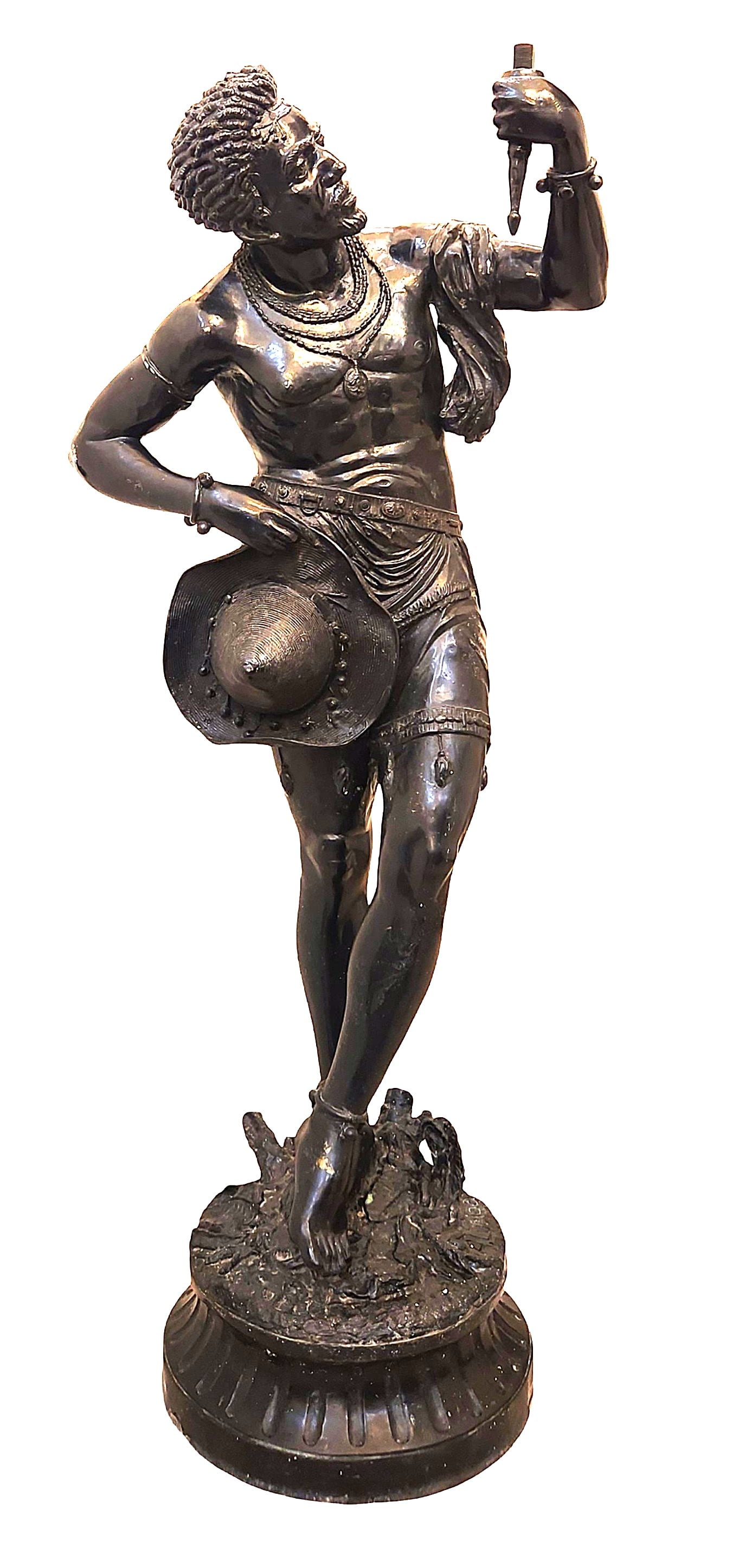 Bronze Figure of an African Warrior, Signed A. Luciga: A striking bronze figure depicting an African warrior, shown in a dynamic contrapposto pose and holding a dagger aloft. The figure is finely modelled with strong anatomical detail, textured hair, and 