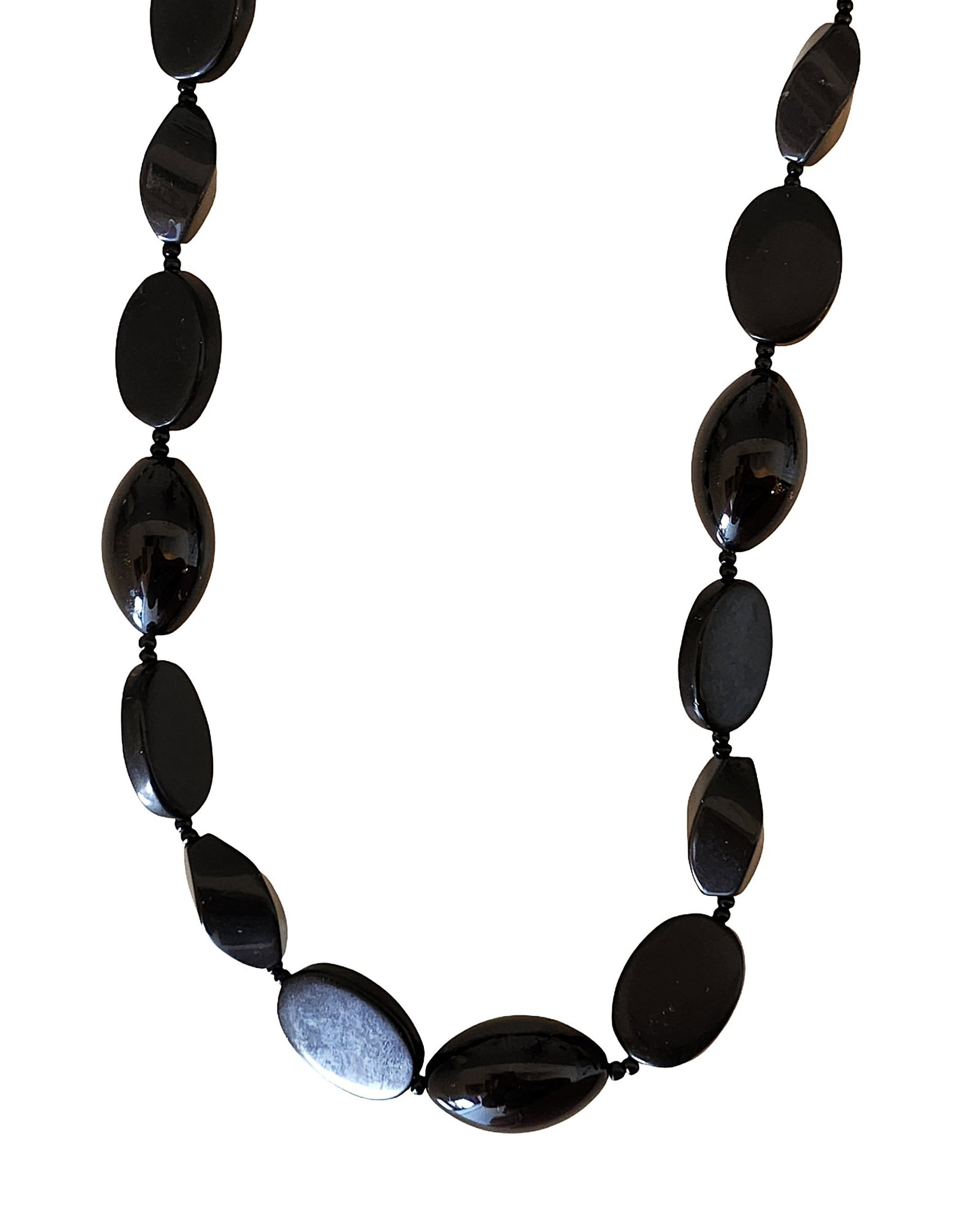 Polished Black Onyx Bead Necklace with Ring Clasp: Elegant necklace composed of polished black onyx beads in alternating oval and elongated shapes. The stones display a deep glossy black finish, creating a sleek and classic monochrome look The beads