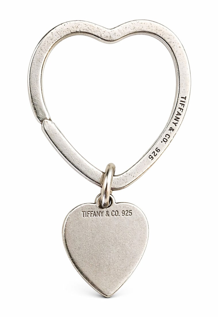Tiffany & Co. Sterling Silver Heart-Shaped Key Ring with Tag and Pouch ? .925: Lovely Tiffany & Co. sterling silver key ring in a heart-shaped open design, accompanied by a matching mini heart charm tag. Both the ring and charm are stamped ?Tiffany & Co. 925,? signifying genuine