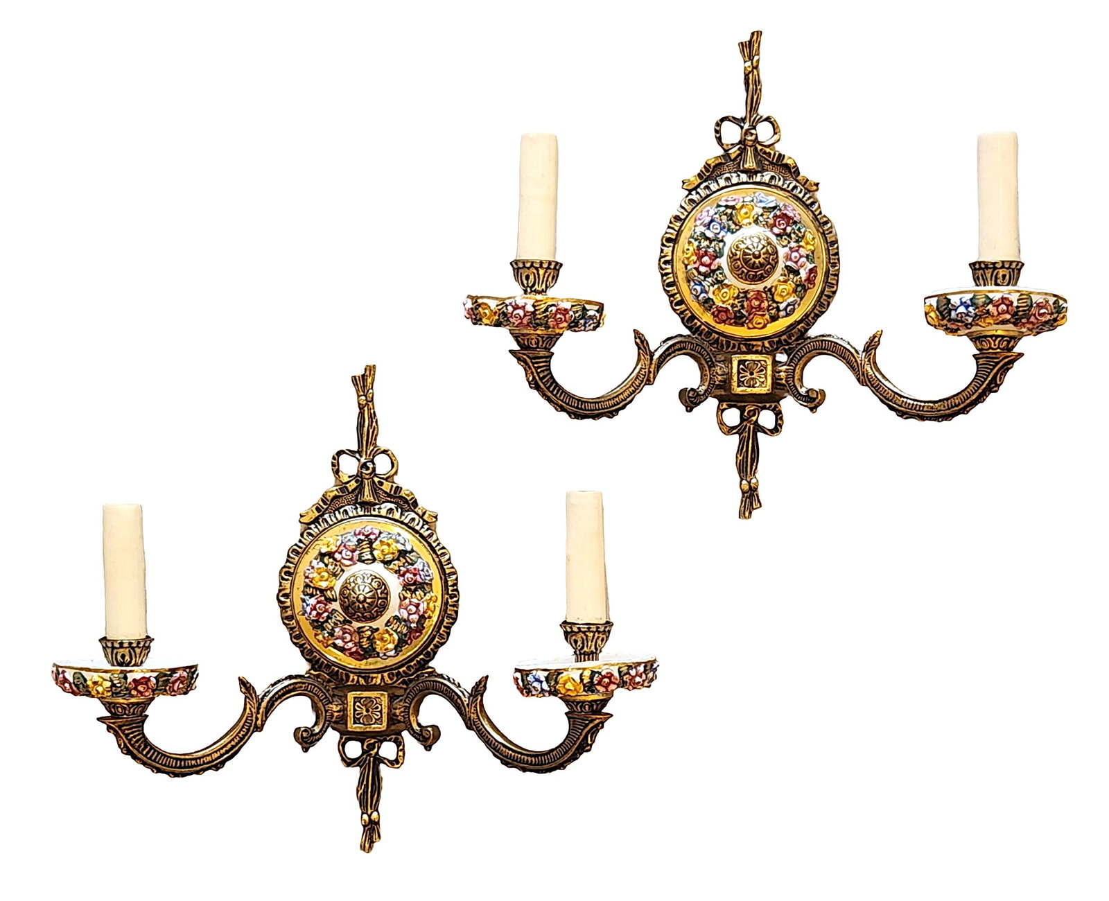 Pair of Bronze and Porcelain Floral Two-Light Wall Sconces, Made in Spain: An elegant pair of decorative two-light wall sconces, crafted in bronze and embellished with hand-painted porcelain floral panels. Each sconce features a central oval medallion decorated with raised p