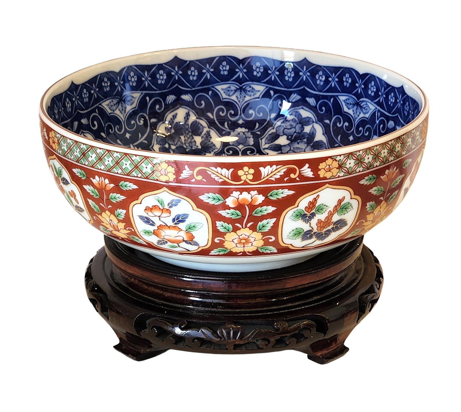 Japanese Imari Porcelain Bowl with Floral Decoration, Marked, 20th Century: A Japanese Imari porcelain bowl, richly decorated with alternating cartouches of floral designs in polychrome enamels against a deep red ground. The interior features an intricate underglaze blue flor