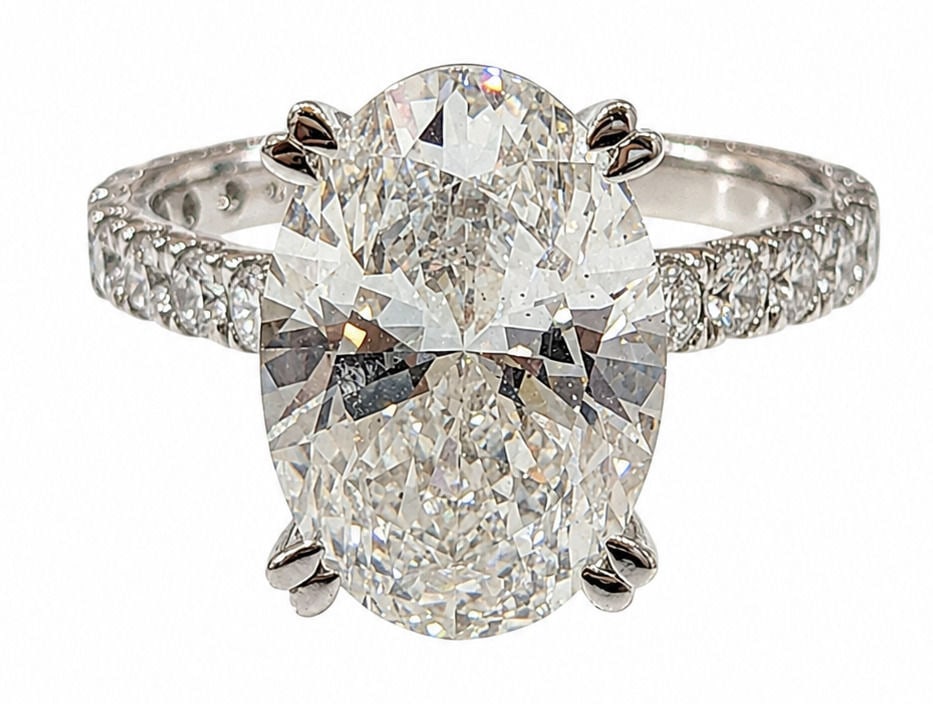 IGI Certified 6.05 Carat Oval Cut Laboratory Grown Diamond Ring in 14K White Gold: Center Diamond Details: Shape: Oval Brilliant Carat Weight: 6.05 Carats Certification: IGI Certified Laboratory Grown Diamond Ring Details: Metal: 14K White Gold Weight: 5.23 Grams Accent Diamonds: 0.
