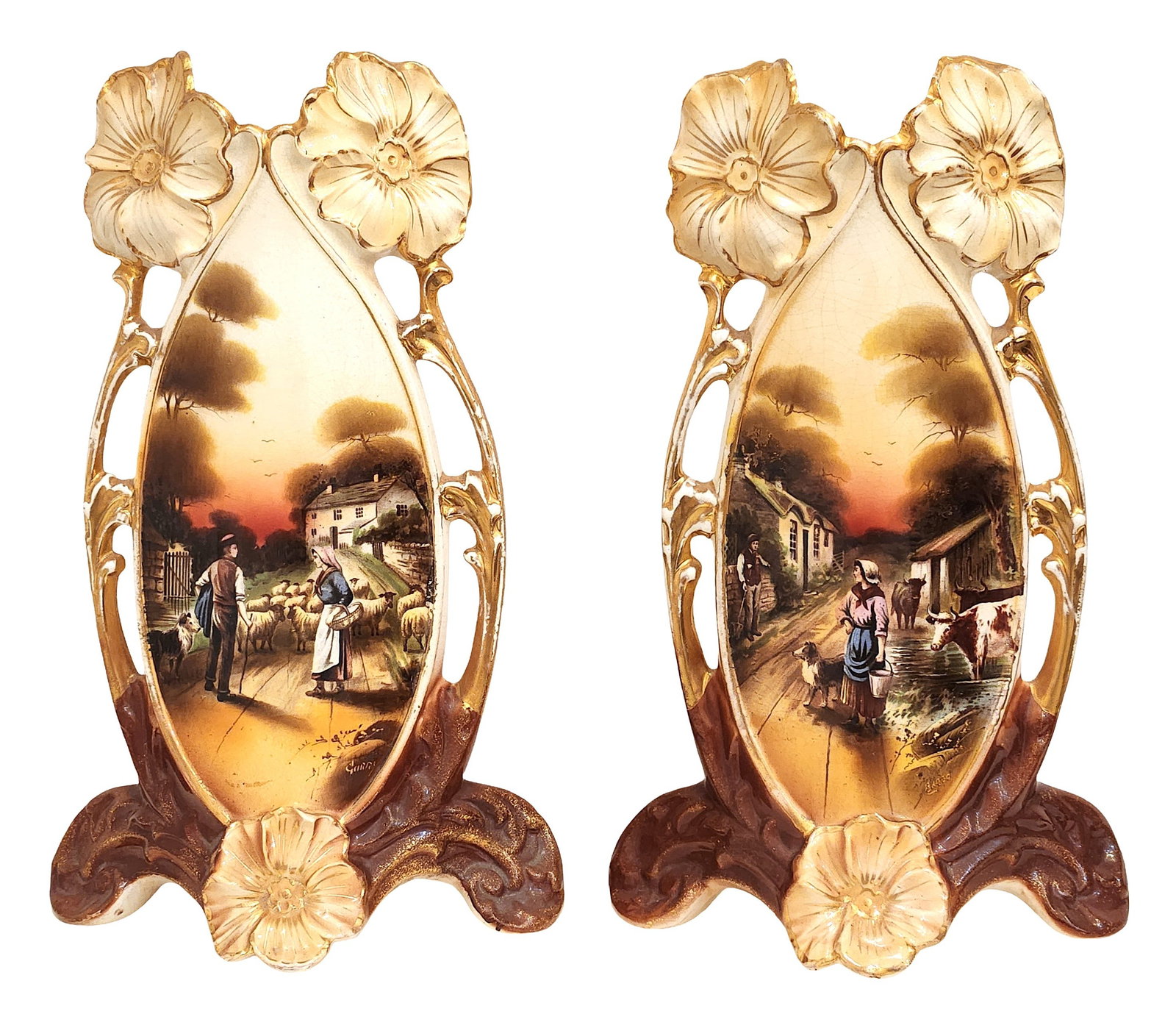 Pair of Art Nouveau Hand-Painted French Porcelain Vases, Signed and Dated: A decorative pair of Art Nouveau style porcelain vases featuring elongated forms with openwork handles and applied floral motifs at the rim and base. Each vase is richly decorated with hand-painted pa