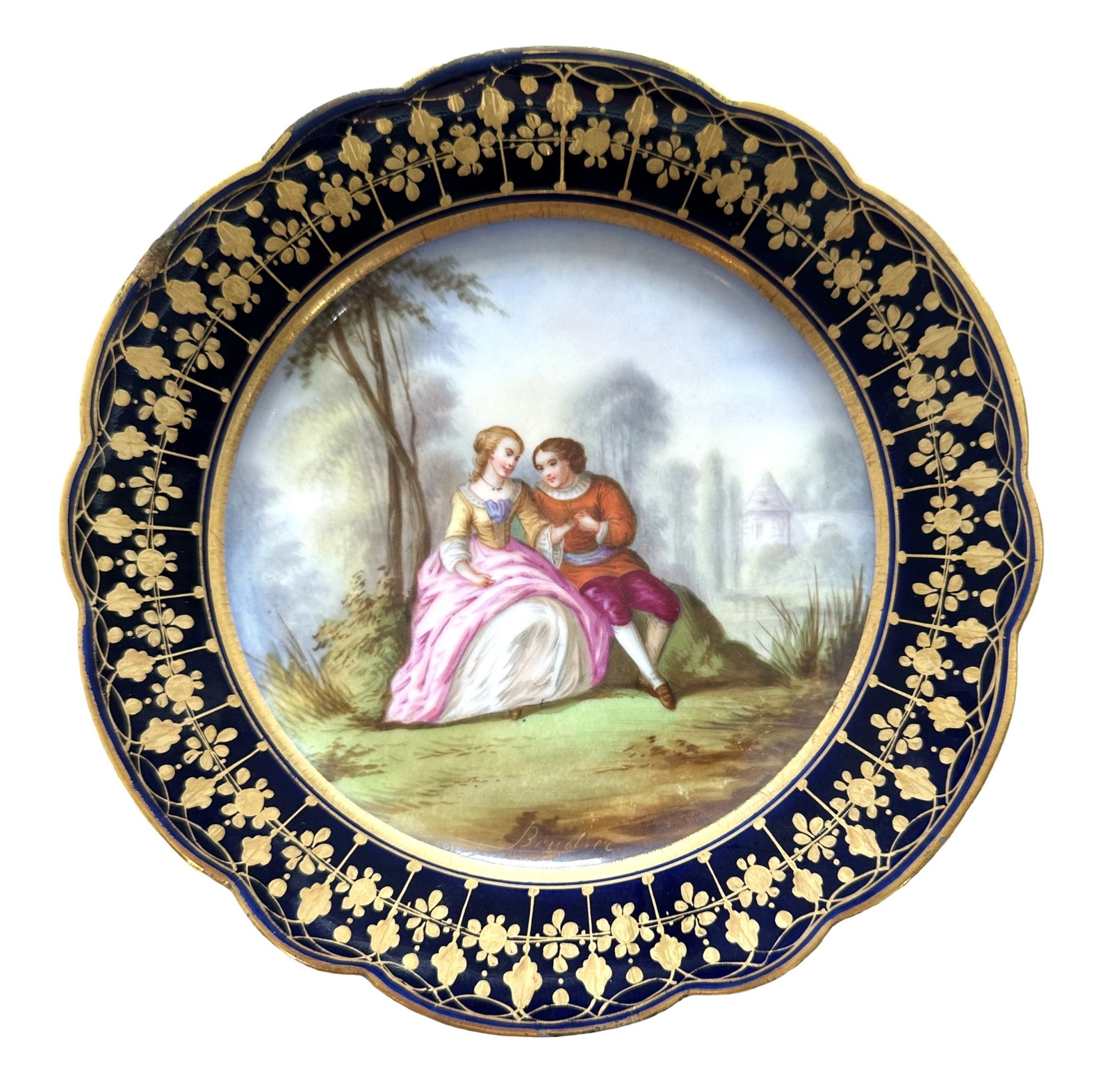 French Sevres Hand-Painted Porcelain Plate with Cobalt Border, Signed Boucher: Elegant French Sevres porcelain cabinet plate featuring a beautifully hand-painted romantic scene of a couple seated in a lush garden landscape. The finely detailed artwork is signed "Boucher" on the 