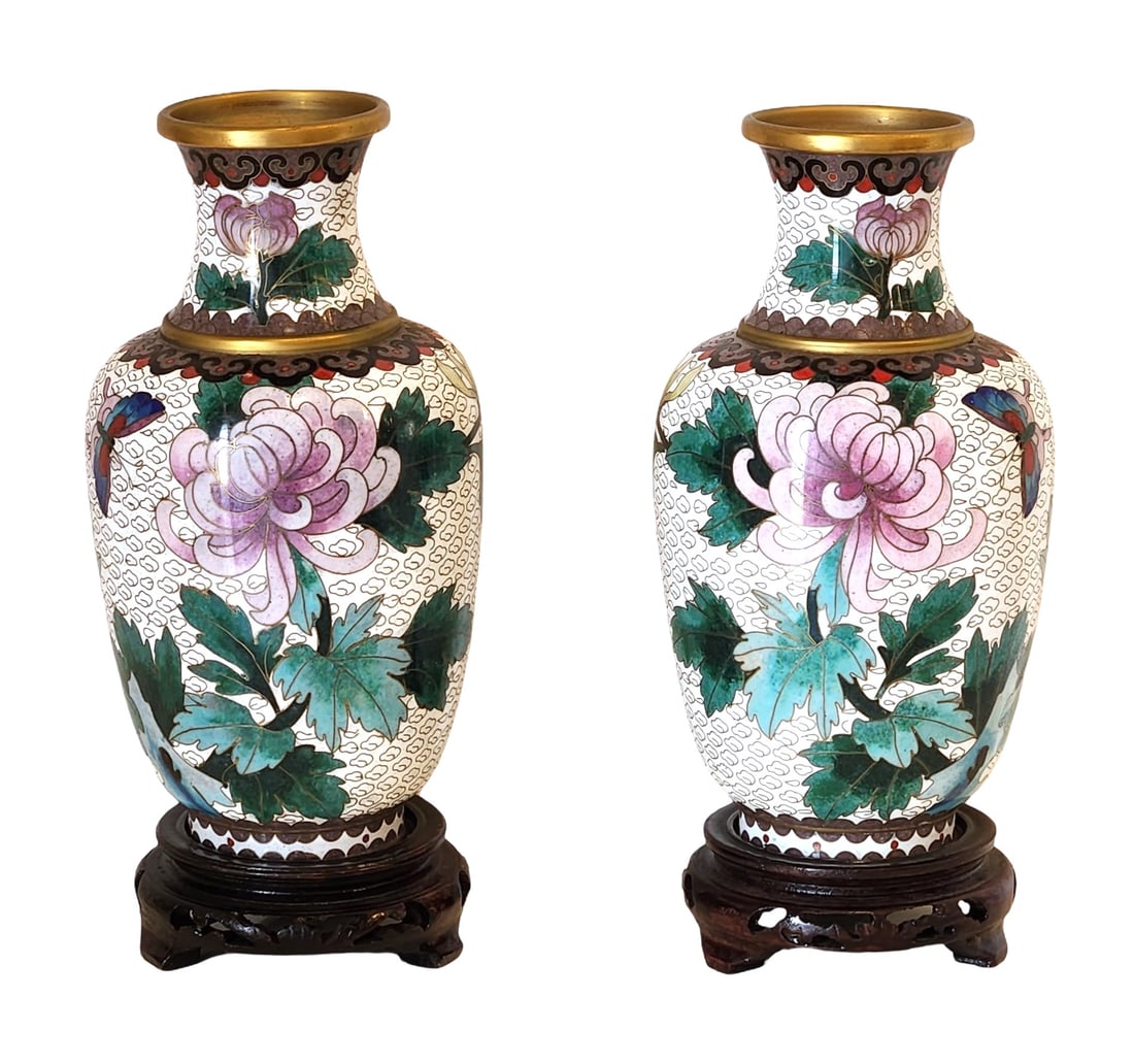 Pair of Chinese Cloisonne Vases with Floral and Butterfly Motifs, 20th Century: A fine pair of Chinese cloisonne enamel vases, each decorated with large pink chrysanthemum blossoms, green foliage, and colorful butterflies on a white cloud-pattern ground. The rims and bases are fi