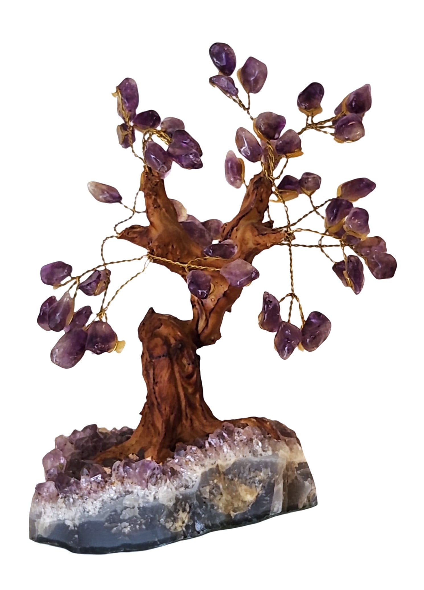 Amethyst Gem Tree Sculpture on Crystal Cluster Base: Striking decorative gemstone bonsai tree sculpture featuring polished amethyst crystal leaves wired onto golden branches, with a hand-crafted resin or natural wood trunk. The tree is rooted in a beaut