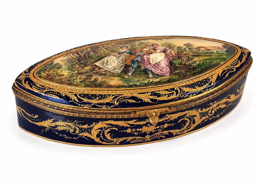 French 19th Century Sevres Porcelain Box: An antique French Sevres hinged and bronze mounted porcelain dresser box. A lid is adorned with a hand painted courting scene with a couple and a lady in a garden. The borders and the body of the ware