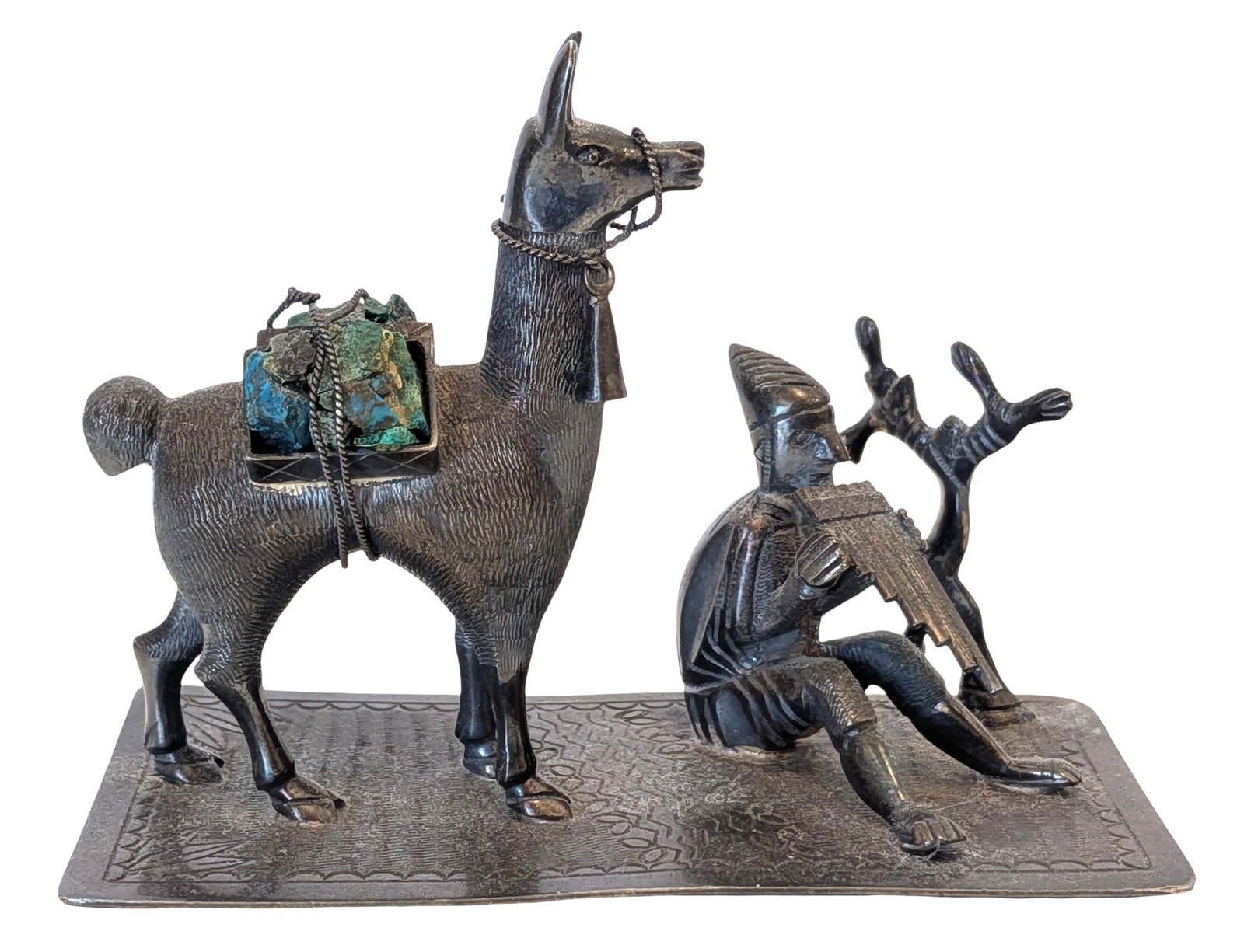 Peruvian 925 Sterling Silver Llama & Pan Flute Player Sculpture with Natural Stone Accents: Charming handcrafted Peruvian sterling silver sculpture depicting a traditional Andean scene featuring a seated pan flute musician beside a laden llama carrying natural mineral specimens. Executed in 