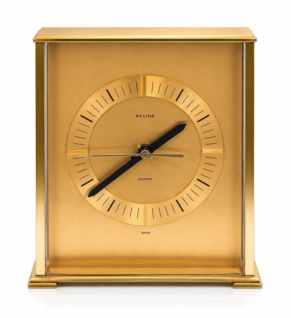 Relide Gilt Brass Quartz Mantel Clock, Mid/Late 20th C.: A modernist rectangular gilt brass mantel clock by Relide, with minimalist dial and baton hour markers. Fitted with a quartz movement by Tochigi Tokei Co., Japan Measure 8 1/4"in H x 7"in W x 3"in D