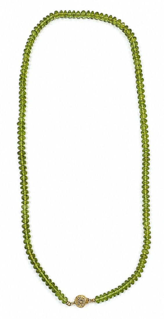 Faceted Peridot Bead Strand Necklace 14K Gold Clasp: A single strand peridot bead necklace composed of faceted, rondelle shaped reen peridot beads displaying natural clarity and brilliance. The strand secures with an ornate 14K yellow gold filigree box 