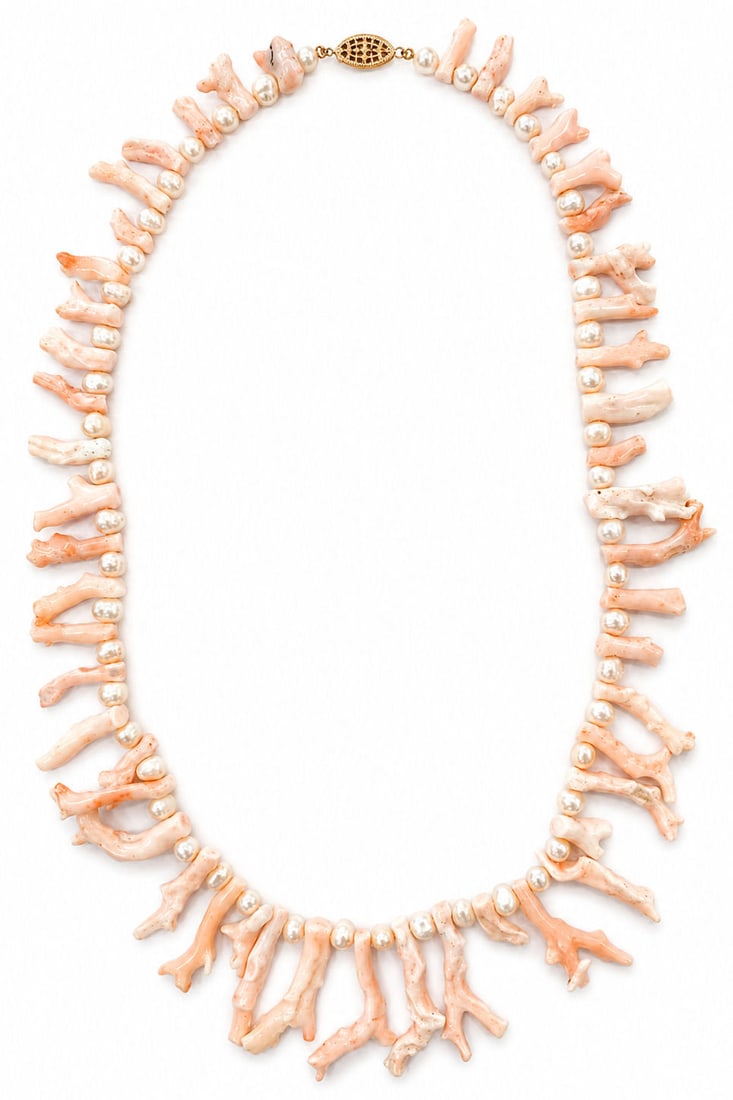 Vintage Angel Skin Coral Pearl Strand Necklace 14K Gold Clasp: A vintage single strand necklace composed of natural light pink " angel skin " coral branch segments alternating with round cultured pearls. The strand is finished with an ornamental 14K yellow gold f