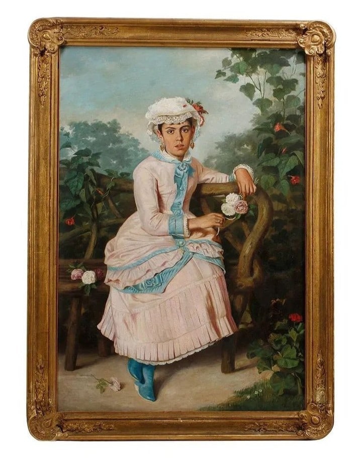 19th Century European Oil Portrait of a Young Lady in a Gilded Frame: An elegant 19th century European oil painting depicting a stylishly dressed young woman seated on a rustic bentwood bench in a lush, flower filled garden. The sitter is rendered in a full skirted pink