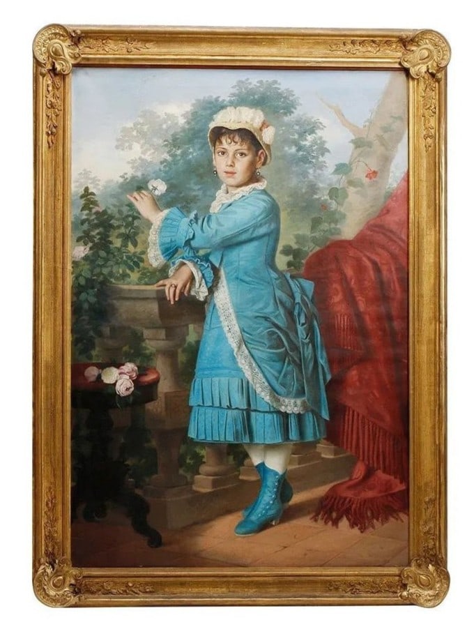 19th Century European Oil Portrait of a Young Girl in Blue on a Terrace: An impressive 19th century European oil portrait depicting a young girl in vibrant period attire standing on a stone garden terrace. The sitter is dressed in a rich sky blue bustle dress trimmed with 