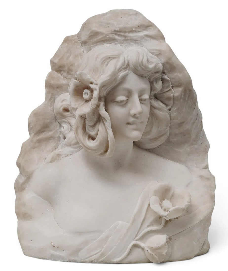 Italian Art Nouveau Carved Marble Bust of a Maiden with Flowers: An elegant late 19th to early 20th century Italian Art Nouveau carved white marble bust depicting a young maiden. The figure is carved with soft, idealized facial features, her head slightly turned wi