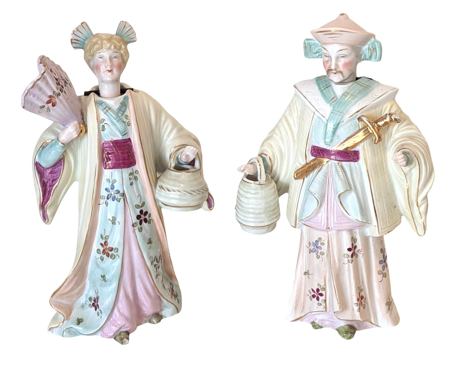 Pair of Vintage Porcelain Asian Figural Nodders: Charming pair of vintage porcelain figural nodders depicting Asian male and female figures in flowing robes with hand-painted floral decoration and pastel glaze accents. The female figure holds a fan 