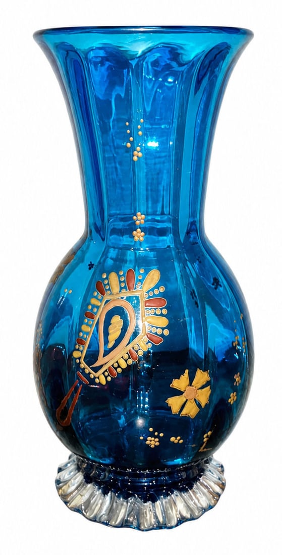 Antique Hand Blown Blue Glass Ribbed Vase with Enamel & Gilt Floral Decoration: An antique hand-blown glass vase crafted in a rich cobalt or turquoise blue hue, featuring a flared rim, a vertical ribbed body, and a clear molded glass base with a ruffled or crimped foot. The body 