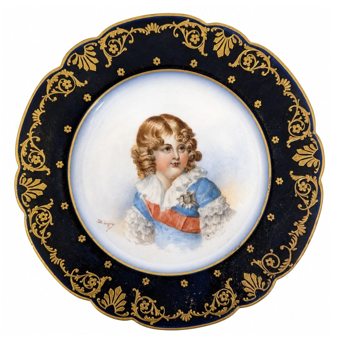 Sevres Hand Painted Porcelain Portrait Plate Signed De Ligny: This fine Sevres porcelain cabinet plate features a hand painted central bust portrait depicting a young boy with golden curls, dressed in a blue jacket with a ruffled white collar, sash, and star ord