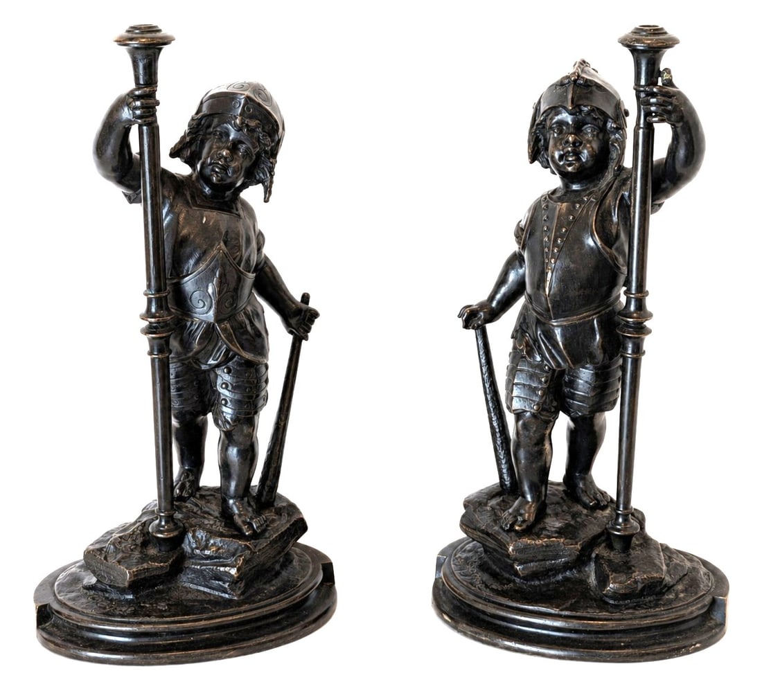 Pair of Antique French Bronze Figures by Paul Auguste Gagne ( French, 19th Century ): An elegant pair of antique French bronze figures by Paul Auguste Gagne ( French, 19th Century ), depicting two young armored pages or medieval attendants standing upon naturalistic oval bases. Each fi