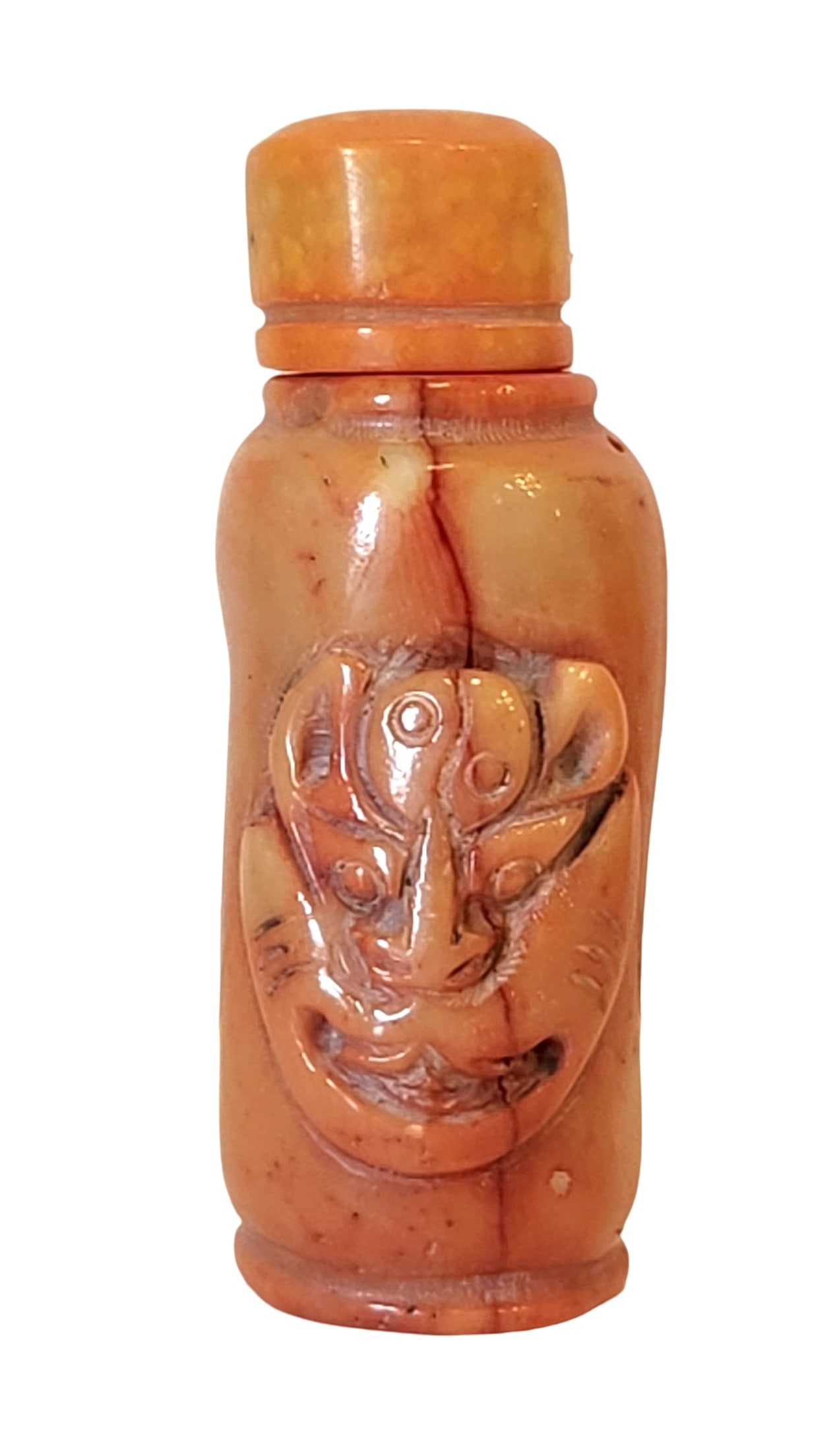 Antique Carved Red Coral Snuff Bottle with Mask Motif, Mid-20th Century: A finely carved red coral snuff bottle featuring a stylized mask motif in relief on the body. The stopper is also coral, fitted with its original spoon. The natural striations and inclusions of the co