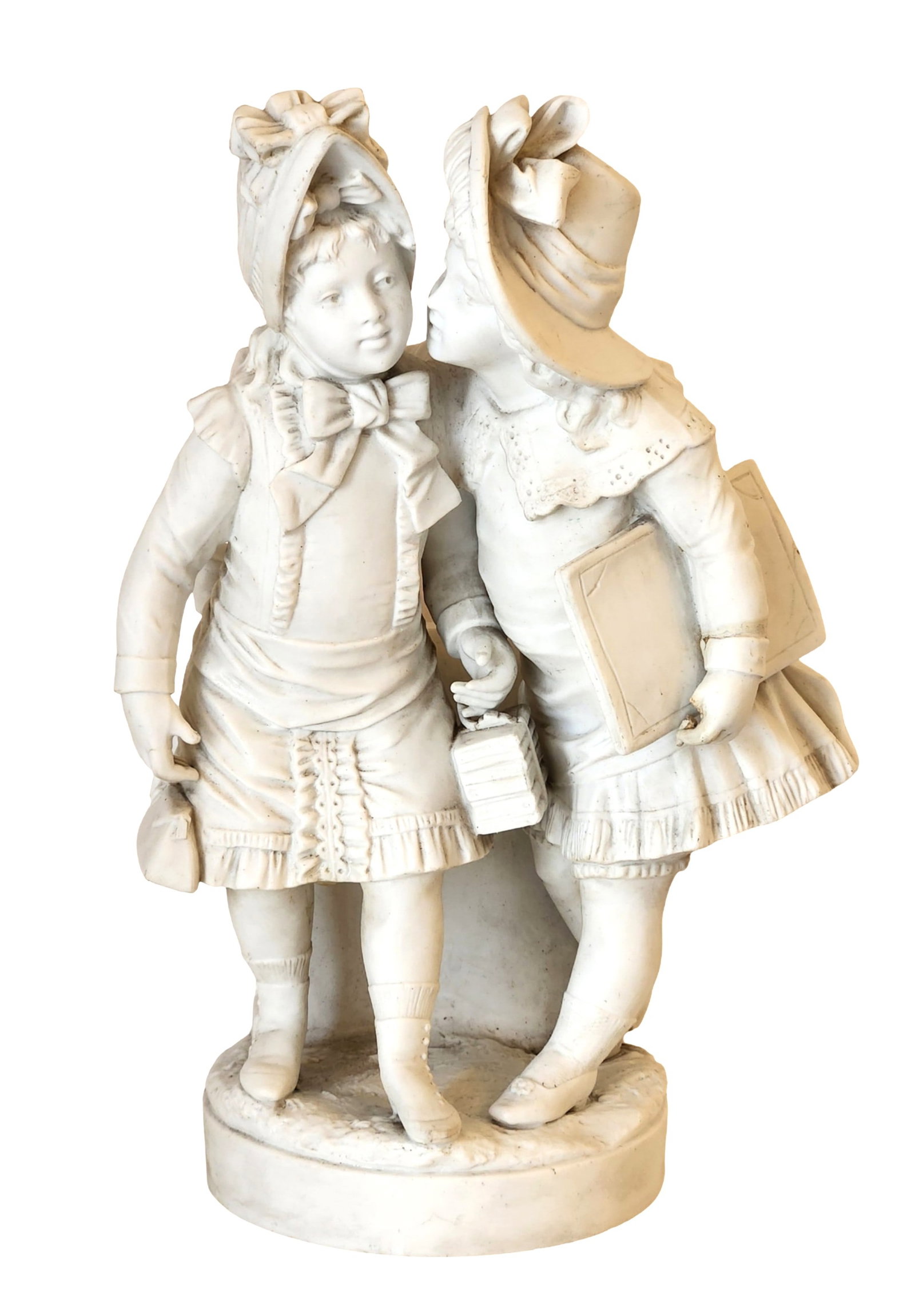 19th Century French Bisque Porcelain Group Two Schoolgirls ": Charming 19th-century bisque porcelain sculpture depicting two young girls dressed in period attire, one whispering into the others ear as they prepare for school, each holding books and a small lante