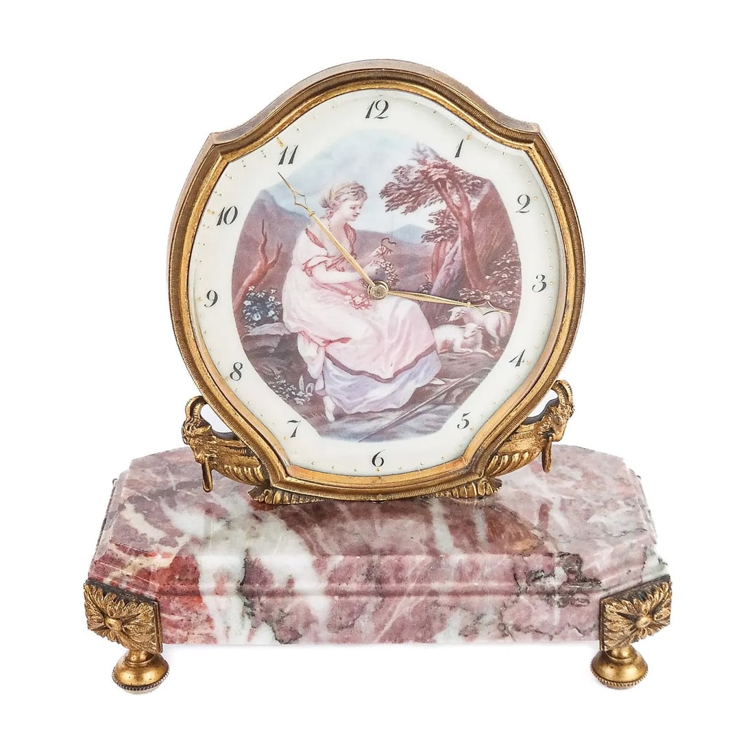Chevron LXVI Marble, Enamel & Bronze Boudoir Clock: Chevron Louis XVI inspired marble, handpainted enamel and bronze boudoir clock retailed by L'Emeraude, Swiss, mark to reverse, with octagonal stepped marble plinth, accented with rams heads Measure
