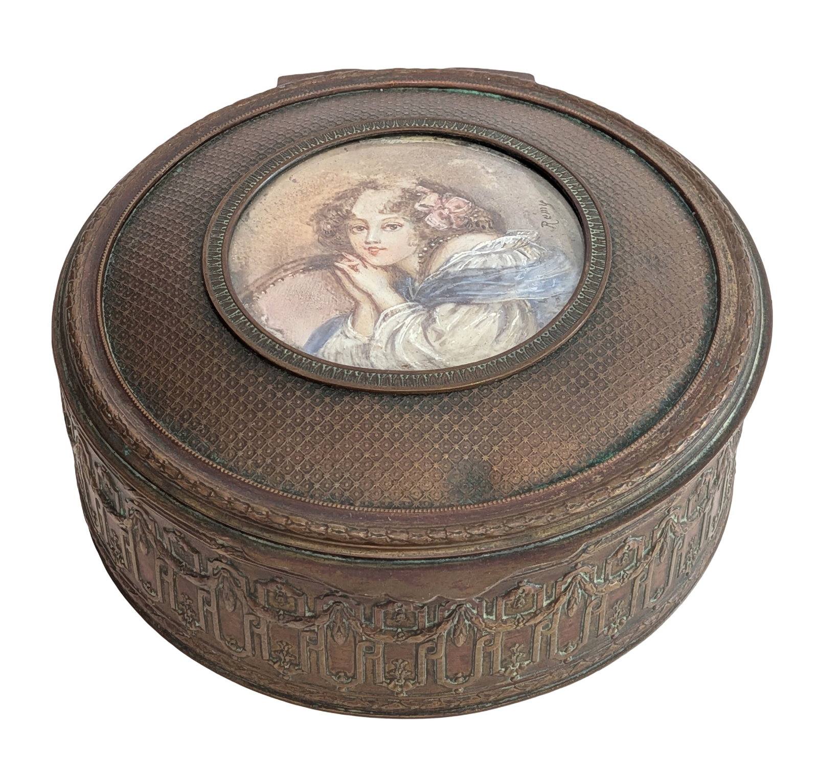 French Style Repousse Brass Jewelry Casket with Portrait Miniature, Early 20th Century: Round embossed brass jewelry casket or trinket box in the French Louis XVI taste, decorated with a continuous neoclassical swag and ribbon motif. The hinged lid features an inset portrait miniature de