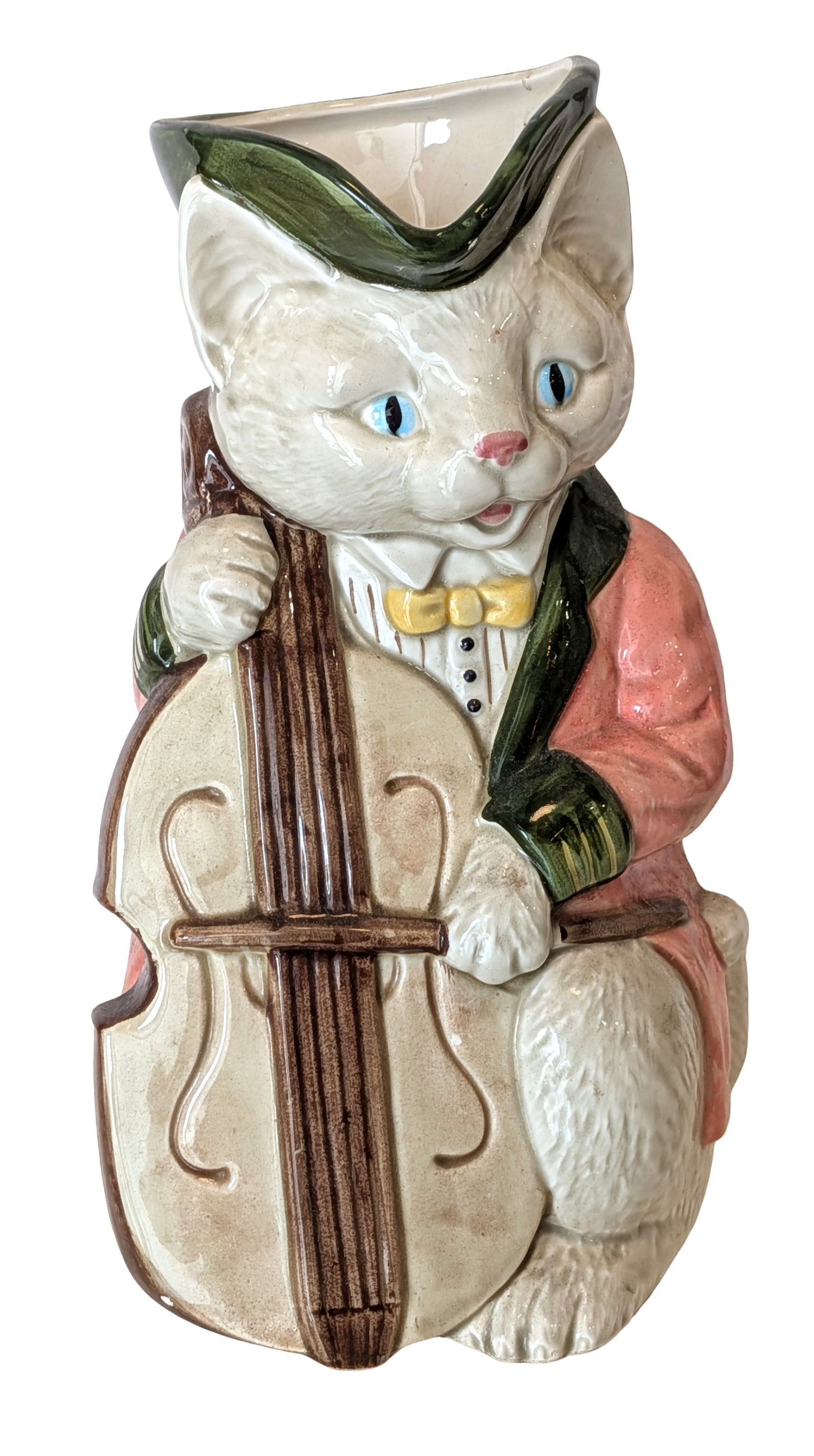 Vintage Cat Cellist Figural Ceramic Pitcher, 1986: Whimsical vintage ceramic figural pitcher modeled as an anthropomorphic white cat playing a cello. The charming feline musician is dressed in a pink coat with green trim and a yellow bow tie, while th