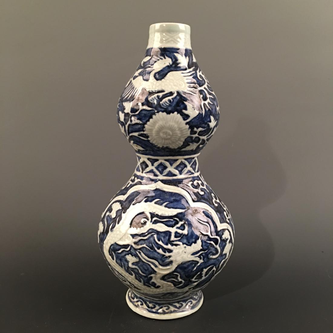 Chinese Blue-White Double Goured 'Dragon' Vase: Chinese Blue-White Double Goured 'Dragon' Vase 10-3/4'' H, 5'' W; 2 lb Shipping: We are able to pack and ship this item to an address in the United States for $35.00 via UPS Ground or USPS Priority Ma