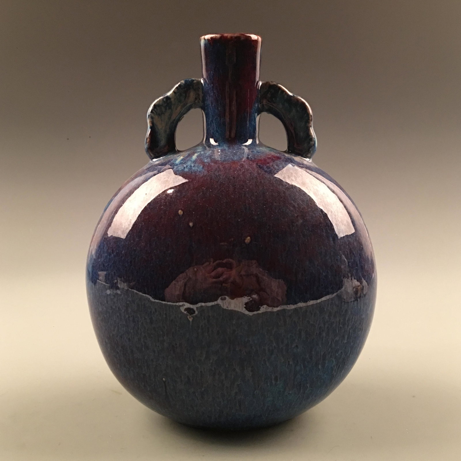 Chinese Flambe-Glazed Moon Flask Vase: Chinese Flambe-Glazed Moon Flask Vase 10-1/2'' H, 7-1/4'' W; 3.8 lb Shipping: We are able to pack and ship this item to an address in the United States for $35.00 via UPS Ground or USPS Priority Mail.