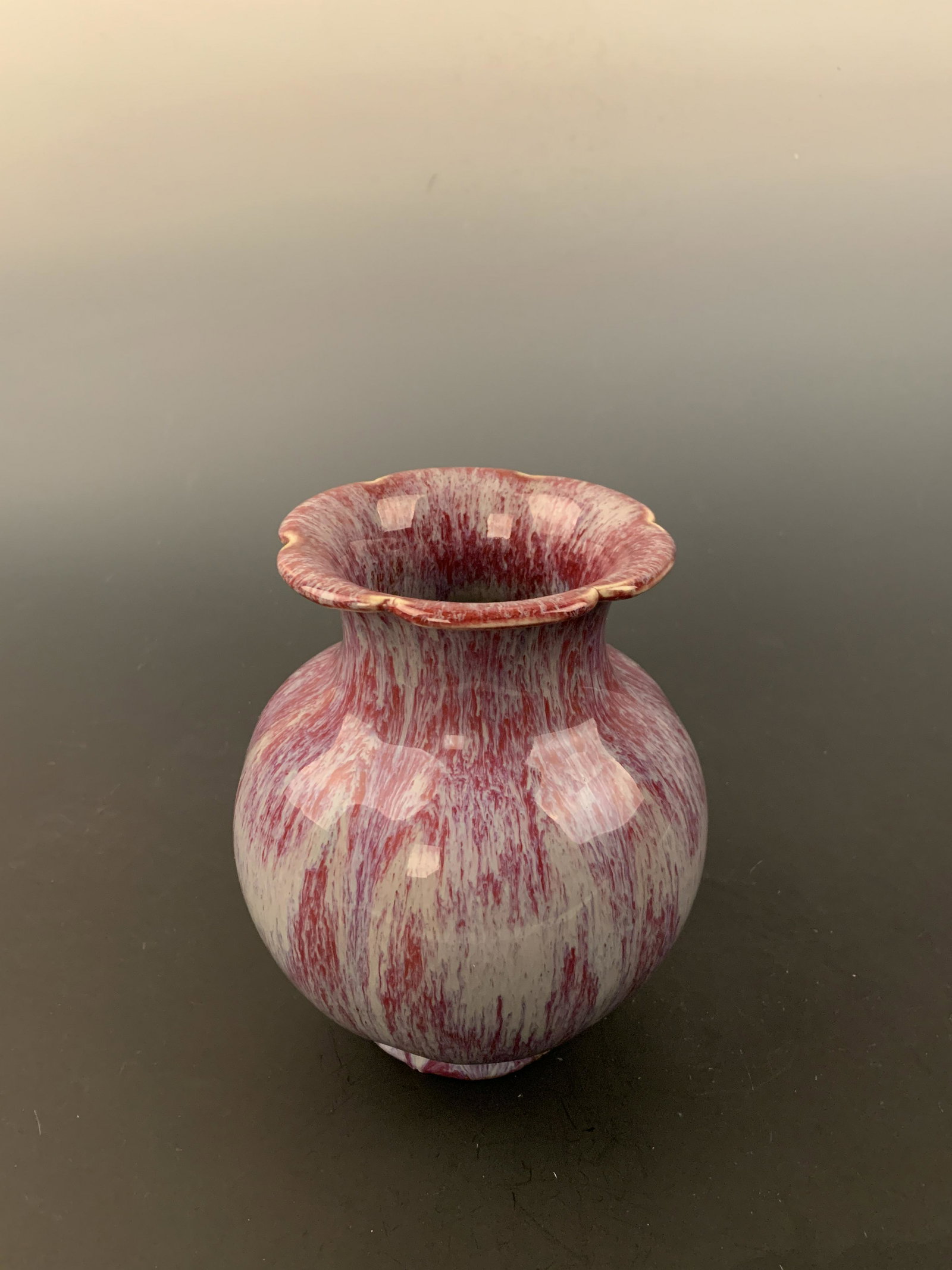 Chinese Flambe Glazed Porcelain Vase with Qianlong Mark: Chinese Flambe Glazed Porcelain Vase with Qianlong Mark 7-1/2'' H, 6-1/4'' W; 2.2 lb Shipping: We are able to pack and ship this item to an address in the United States for $35 via UPS Ground or USPS 