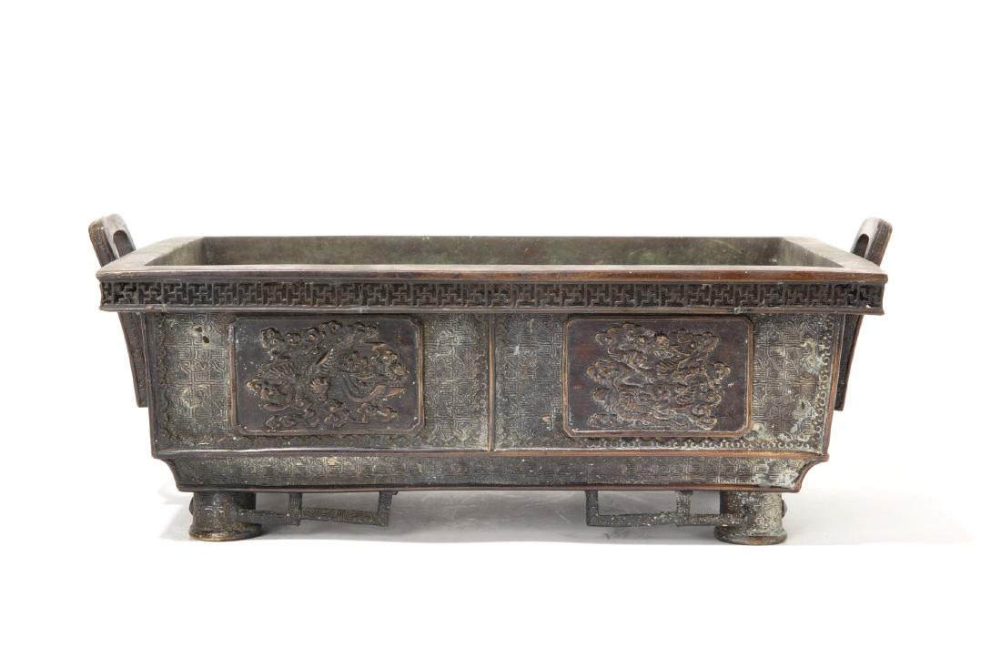 A Japanese bronze hibachi Meiji Period: A Japanese bronze hibachi Meiji Period With cast character marks to underside height 6 3/4in (17cm); length over handles 17 1/2in (44.5cm)