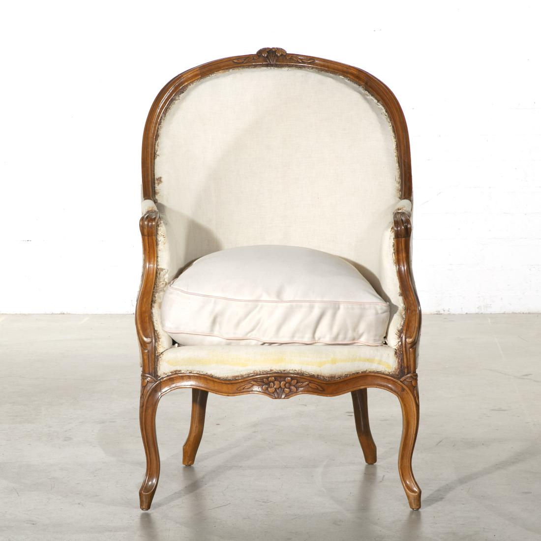 A Louis XV style carved beechwood bergere: A Louis XV style carved beechwood bergÃ¨re late 19th century height 42in (107cm); width 26 1/2in (67cm); depth of seat 21 1/2in (55cm)