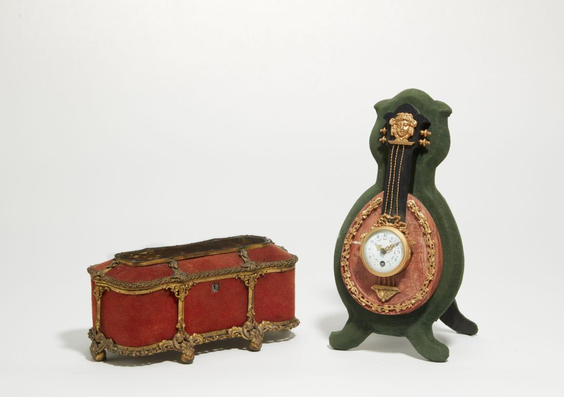 A French lyre form clock and a table casket: A French gilt metal mounted marble lyre form easel back table clock late 19th century With single train movement; together with a Baroque style gilt bronze mounted table casket. (2) the clock height 1