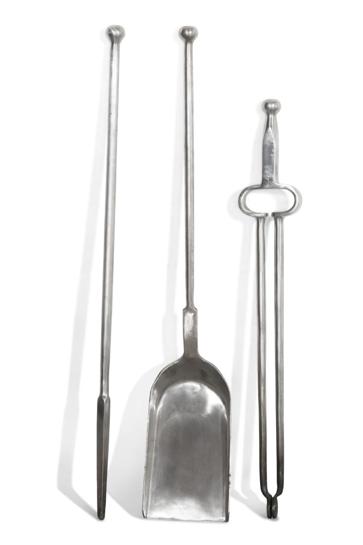 A set of three steel fire irons, Jamb: A set of three polished steel fire irons probably Jamb 20th century Comprising tongs, poker and shovel. length of poker 31in (79cm)