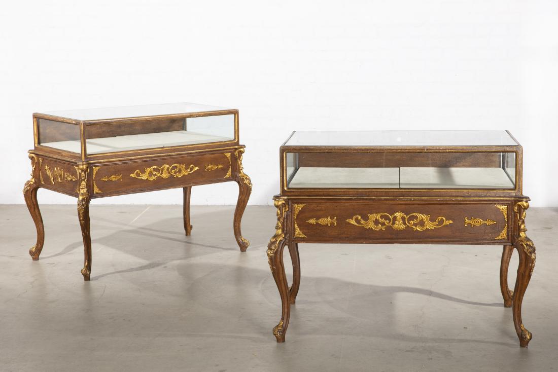 Pair Rococo style parcel gilt wood display cases: A pair of Rococo style parcel gilt carved mixed wood display cases 20th century height 41in (104cm); width 54in (137cm); depth 34in (86.5cm)