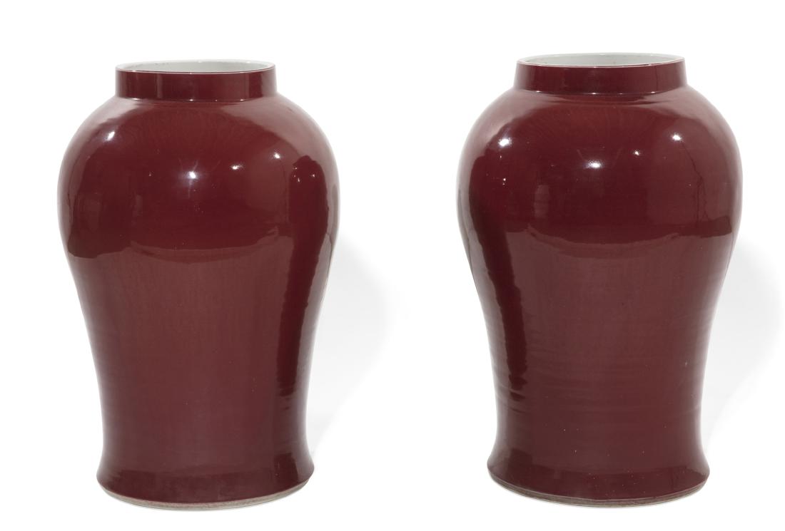A pair of Chinese 'Sang de Boeuf' baluster vases: A pair of Chinese 'Sang de Boeuf' baluster vases 20th century height 25in (63.5cm); diameter 14 1/2in (37cm)
